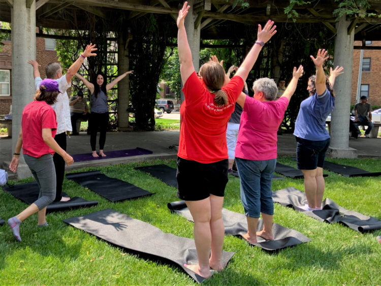 people outside doing yoga