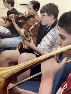 four young people playing instruments