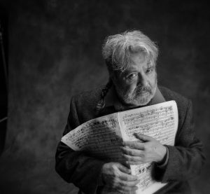 blank and white photo of man holding music