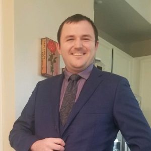 Young man in a suit, smiling