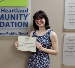Student holding her scholarship certificate