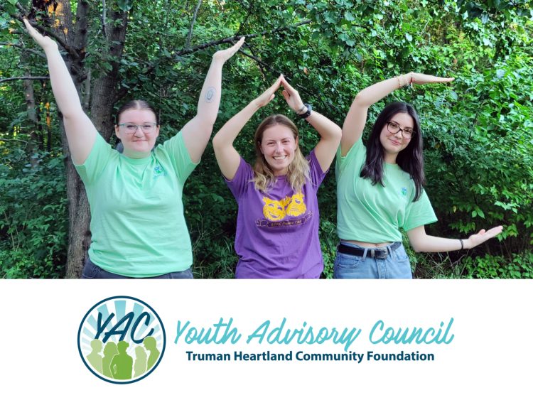 Young ladies using their arms to spell out Y-A-C